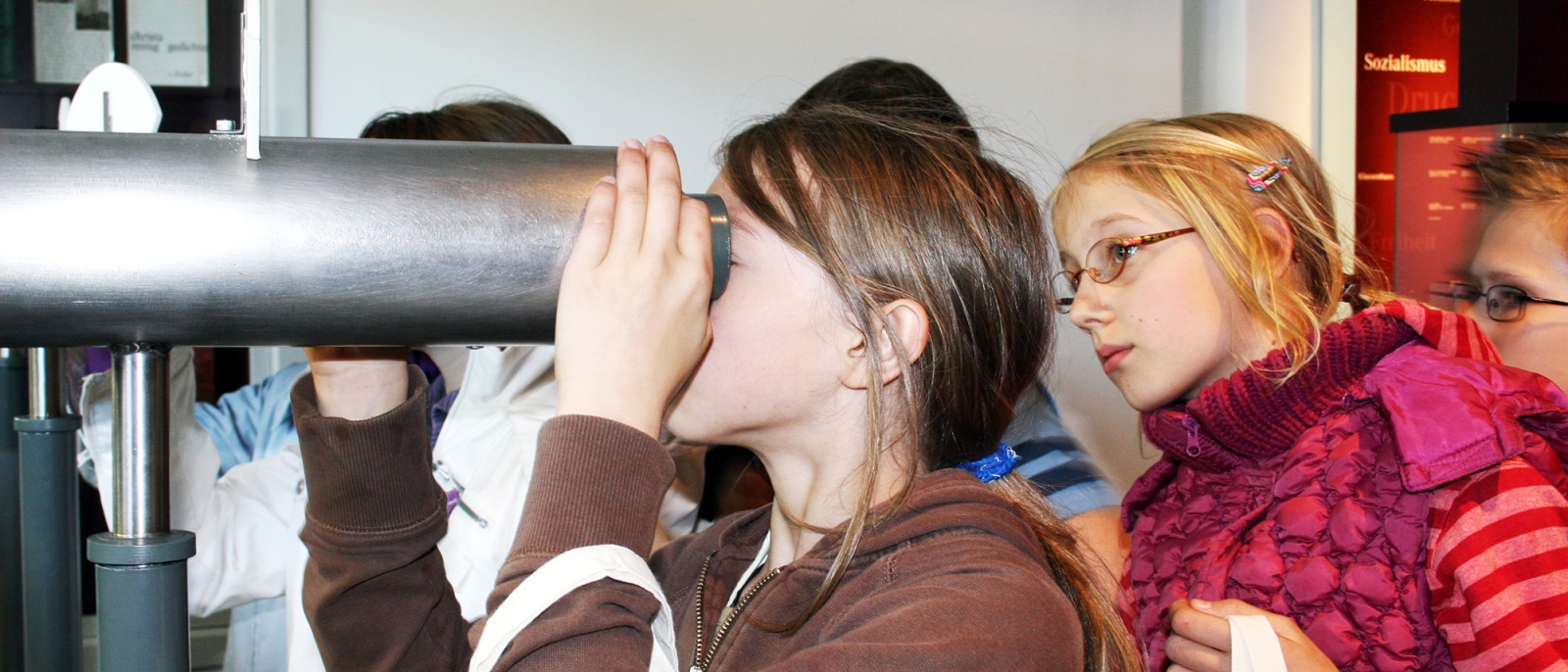 Children looking through a telescope